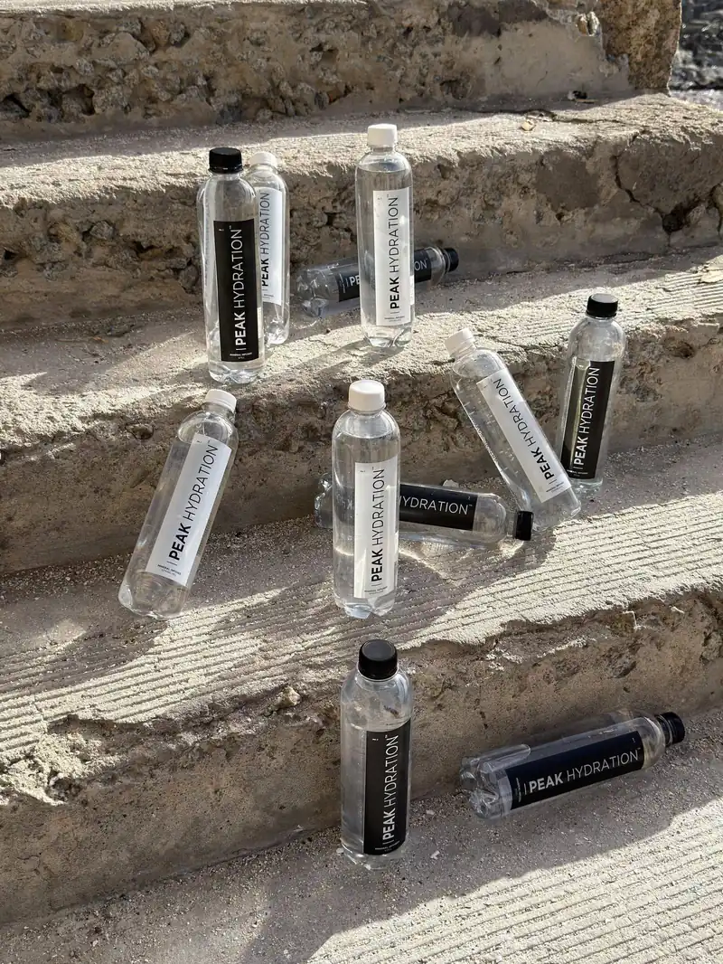 Peak Hydration bottles across sunlit concrete steps