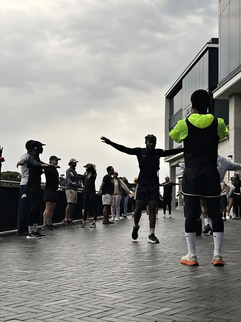 A group warm-up before a community run